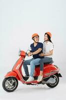 image of asian couple riding scooter on white background photo