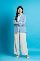 Asian young businesswoman portrait on blue background photo