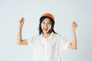 woman wearing orange helmet on white background photo