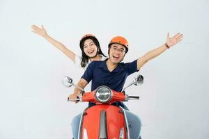 A couple wearing helmets and riding a motorbike photo