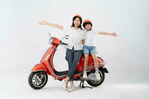 mother and son wearing helmets and riding motorbikes photo