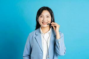 portrait of asian business woman posing on blue background photo