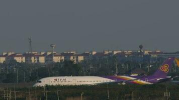 BANGKOK, THAILAND JANUARY 19, 2023 - Airbus A350 of Thai Airways on runway at Suvarnabhumi Airport, side view. Passenger flight speed up before takeoff. Tourism and travel concept video