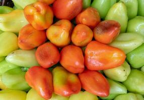 Bulgarian pepper is green and red in the basket photo