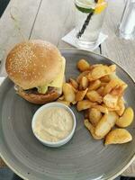 Sombrero hungarian burger with steak potatoes and garlic cream photo