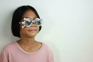 Child eye test in optical store, kid eye check in clinic photo