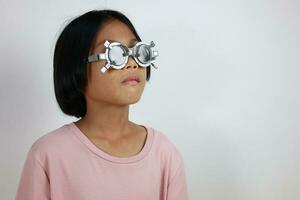 Child eye test in optical store, kid eye check in clinic photo