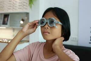 Eye care, Child wearing glasses in the optical store, kid eye test, children eye check, eye exam, child eye test, photo