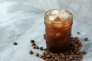 Iced Black Coffee or Ice Americano on Grey Cement Table. photo