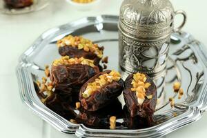 Dates Stuffed with Cream Cheese, Peanut Butter, and Pistachios. photo