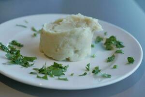 Mashed potatoes in bowl on wooden rustic table photo