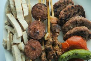 Kebab, traditional turkish meat food with salad on a plate . photo