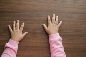 top view of baby hand on table photo