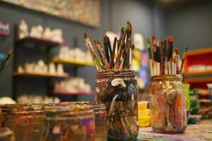 Paints and paint brushes in an artists studio. photo