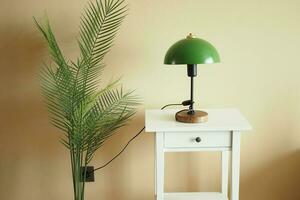 a table lamp in home against orange color wall photo