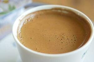 top view of hot coffee with bubble on white background photo