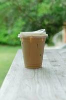 Iced coffee on wooden table photo