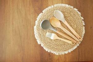 wooden cutlery forks on light yellow background photo
