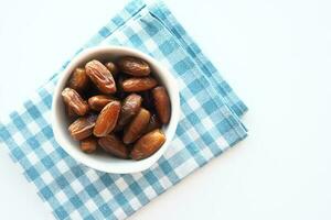 close up of fresh date fruit in a bowl on table photo