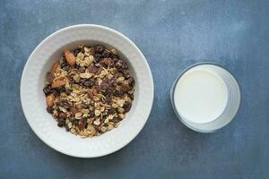 top view of granola Musli in a bowl and glass of milk on table photo