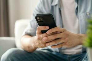 Man using smartphone typing, chatting conversation, watching video live streaming. Social network, technology concept photo