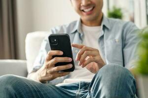 Man using smartphone typing, chatting conversation, watching video live streaming. Social network, technology concept photo