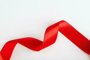 Red silk ribbon for wrapping gifts on white background. photo
