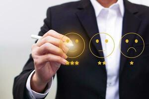 Businessman give rating satisfaction using a stylus pen. Evaluate quality of service and feedback survey concept. photo