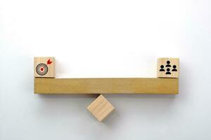 People icon and target on wooden seesaw. Concept of the balance in teamwork, collaboration and cooperation. photo