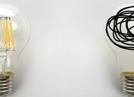 Concept of fail and success, problem solving. Glowing light bulb and a tangle of thoughts in a lightbulb. photo