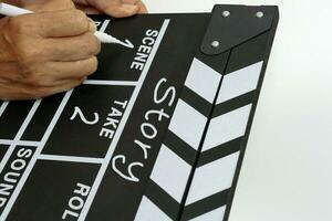 Focus the hand is holding clapperboard or movie slate black color and marker pen. Cinema industry concept. photo