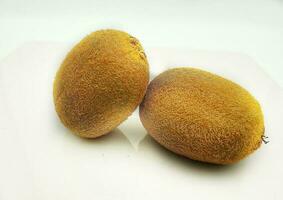 pair of kiwis on a white background. An exotic fruit in the Italian cuisine of 2023 photo