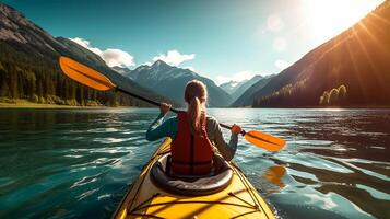 Young woman kayaking on mountain lake. Adventure and sport concept photo