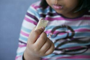 a child eating a wafer roll chocolate photo