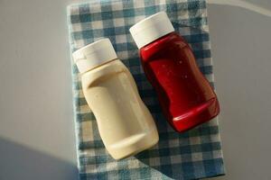 close up of Mayonnaise in container on table . photo