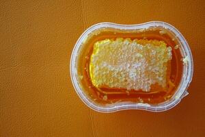 close up of fresh honey with comp in a jar photo