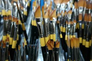 Paints and paint brushes in an artists studio. photo