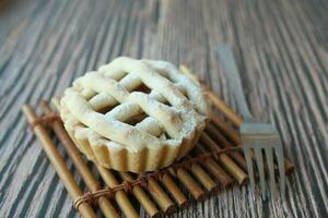 Homemade apple pie with lattice pastry on table photo