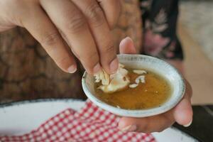 butter cream and honey in a bowl on table . photo