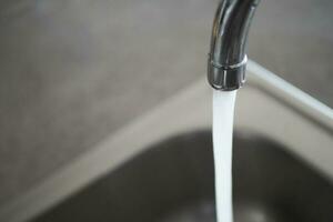 water pouring from a faucet tap slow motion photo