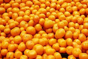 fresh orange fruits display for sale at local market photo