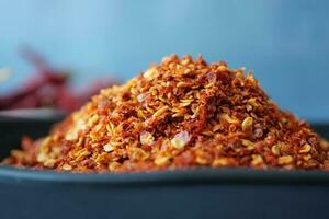 chili flakes in a bowl on table photo
