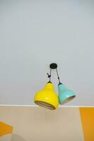 yellow and green ceiling lamp hanging in a room , photo