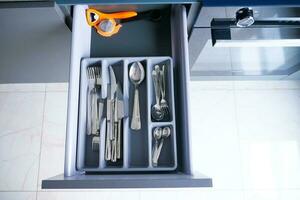 cutlery fork with knife and spoon in a drawer photo