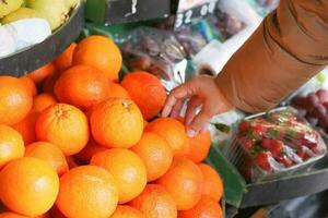 women buying oranges at the farmer's market photo