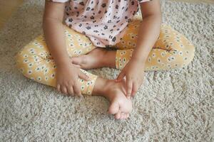 child girl suffering from itching skin, close up. photo