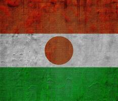 Flag of Republic of Niger on a textured background. Concept collage. photo