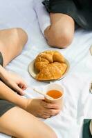 Eco-friendly picnic for schoolchildren in the park. Croissants on eco paper plates and apple juice in an eco cup with a straw on a white blanket. Back to school concept photo