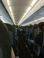 Russia, St. Petersburg, Pulkovo - May 22, 2021. Interior of airplane with passengers sitting on seats photo