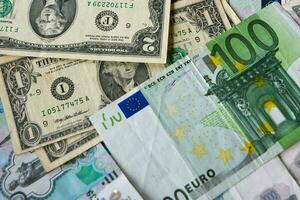 background of paper bills dollars, euros and rubles. Currency exchange rate photo